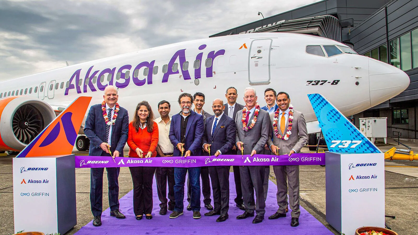 Executives from Akasa Air and Boeing at a ribbon-cutting ceremony in front of a new 737-8 aircraft, celebrating a strategic airline partnership with branding from Akasa Air, Boeing, and Griffin Global Asset Management.