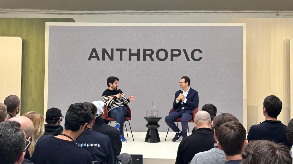 Anthropic AI event with two speakers on stage discussing artificial intelligence and safety in front of a live audience.