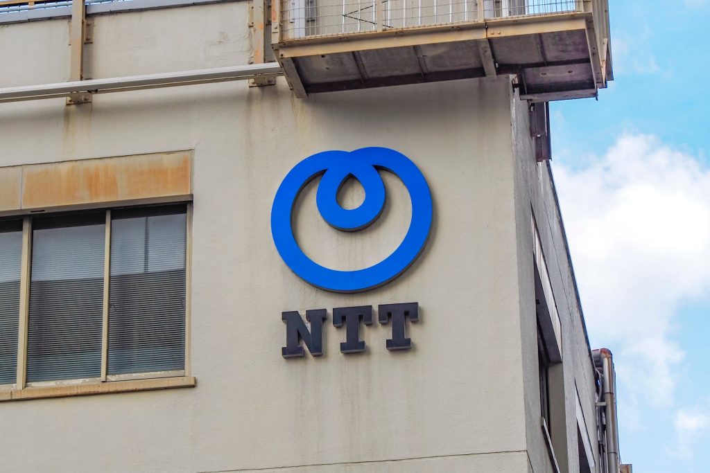 NTT logo on the exterior wall of an office building, highlighting Japan’s telecommunications and IT group.