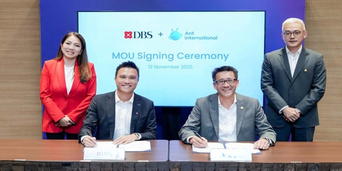 Executives from DBS and Ant International signing an MOU at a formal ceremony on 12 November 2025, with representatives standing behind them in a corporate setting.
