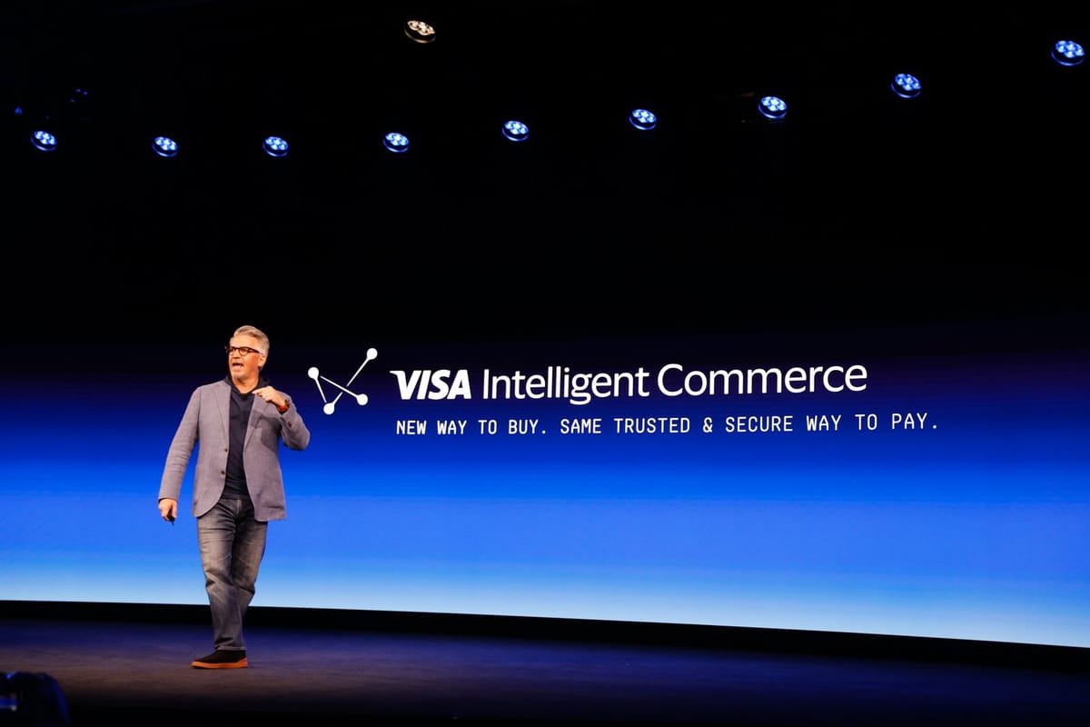 Visa executive presenting the Visa Intelligent Commerce platform on stage, highlighting a new way to buy with trusted and secure payment technology.