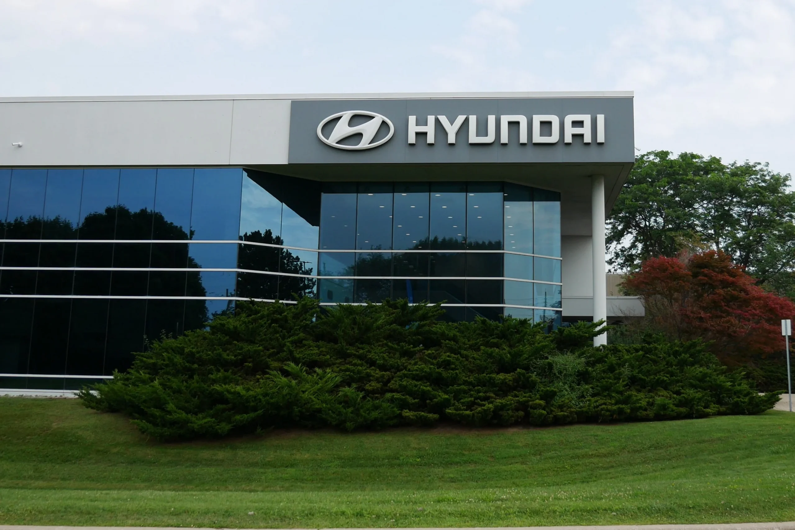 Hyundai corporate building exterior with modern glass architecture and company logo, representing global automotive innovation and technology.