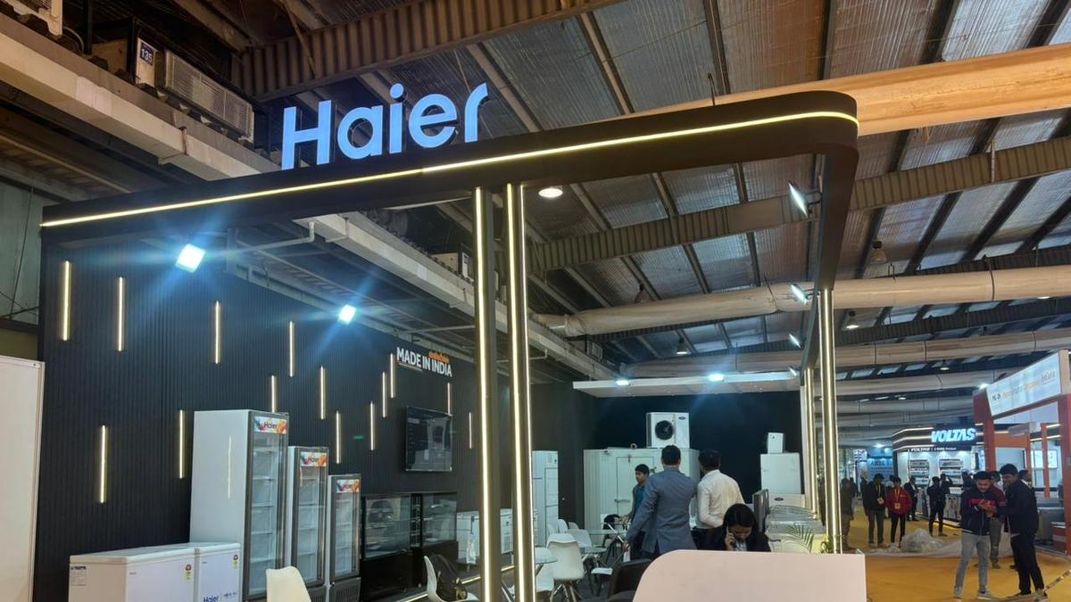 Haier exhibition booth showcasing refrigerators and home appliances at an indoor trade show, featuring modern lighting, ‘Made in India’ signage, and visitors engaging with product displays.