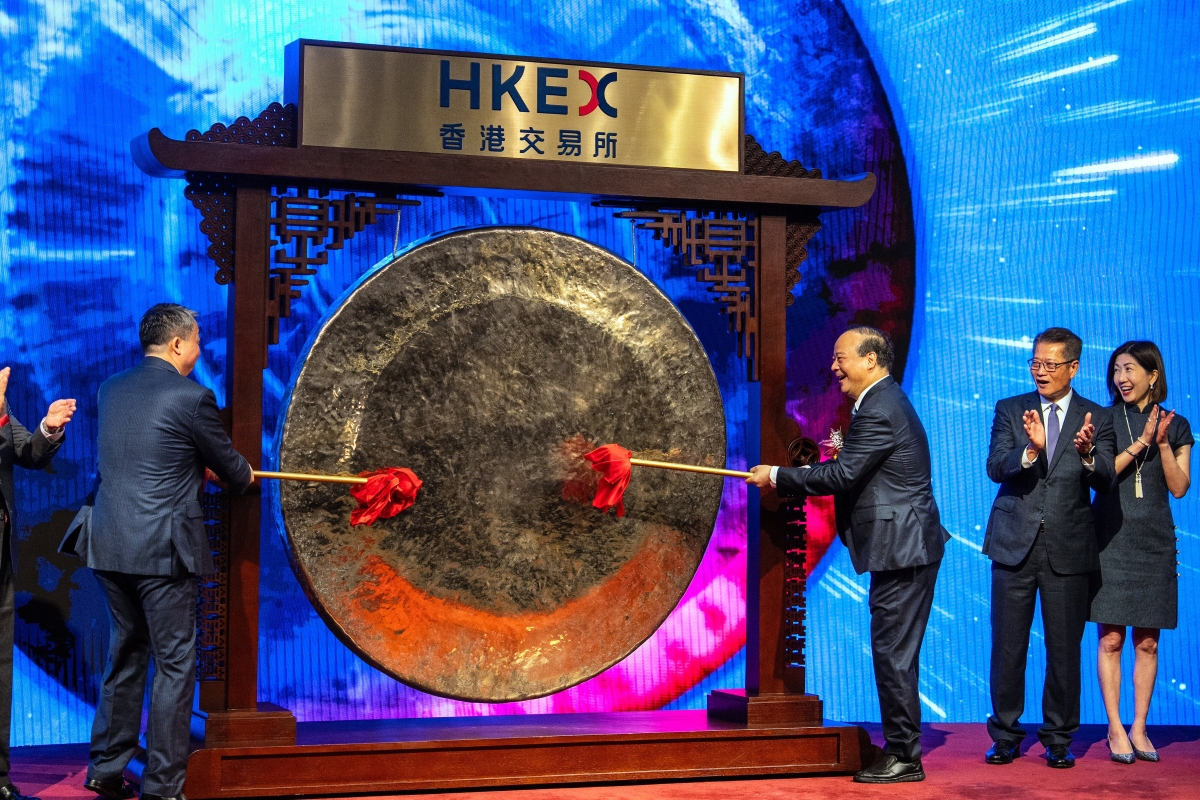 Hong Kong Exchanges and Clearing (HKEX) opening gong ceremony, with senior executives striking a traditional gong on stage during a market event in Hong Kong.