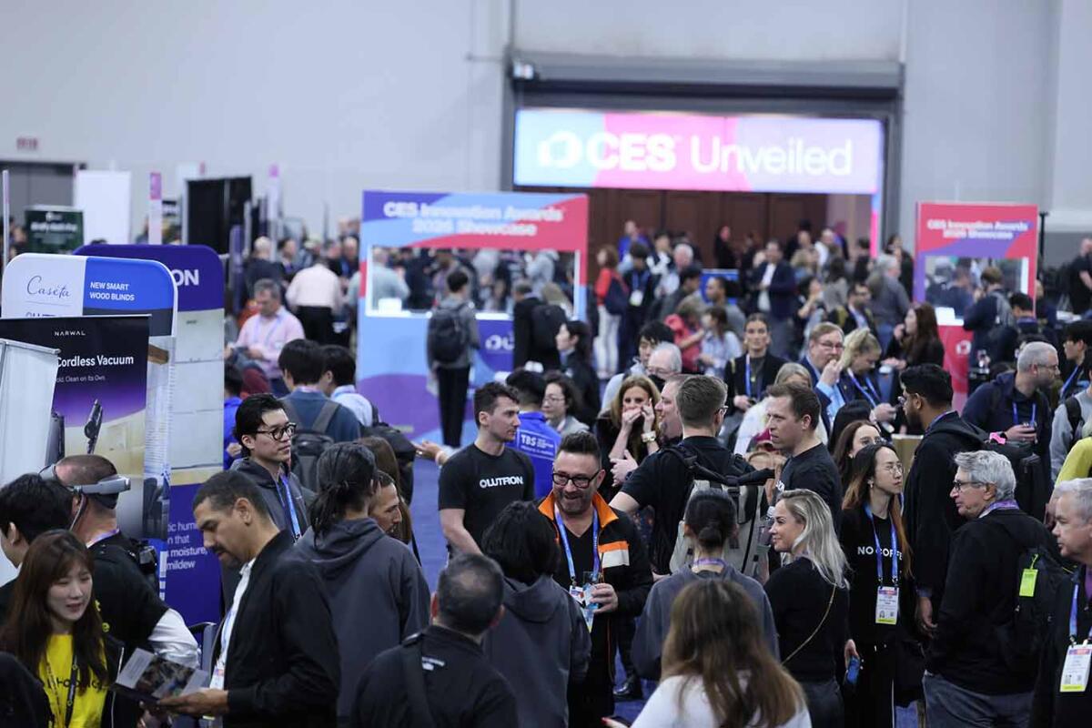 Crowded exhibition hall at CES Unveiled, with global tech attendees exploring startup booths and consumer electronics innovations during the annual CES technology showcase.