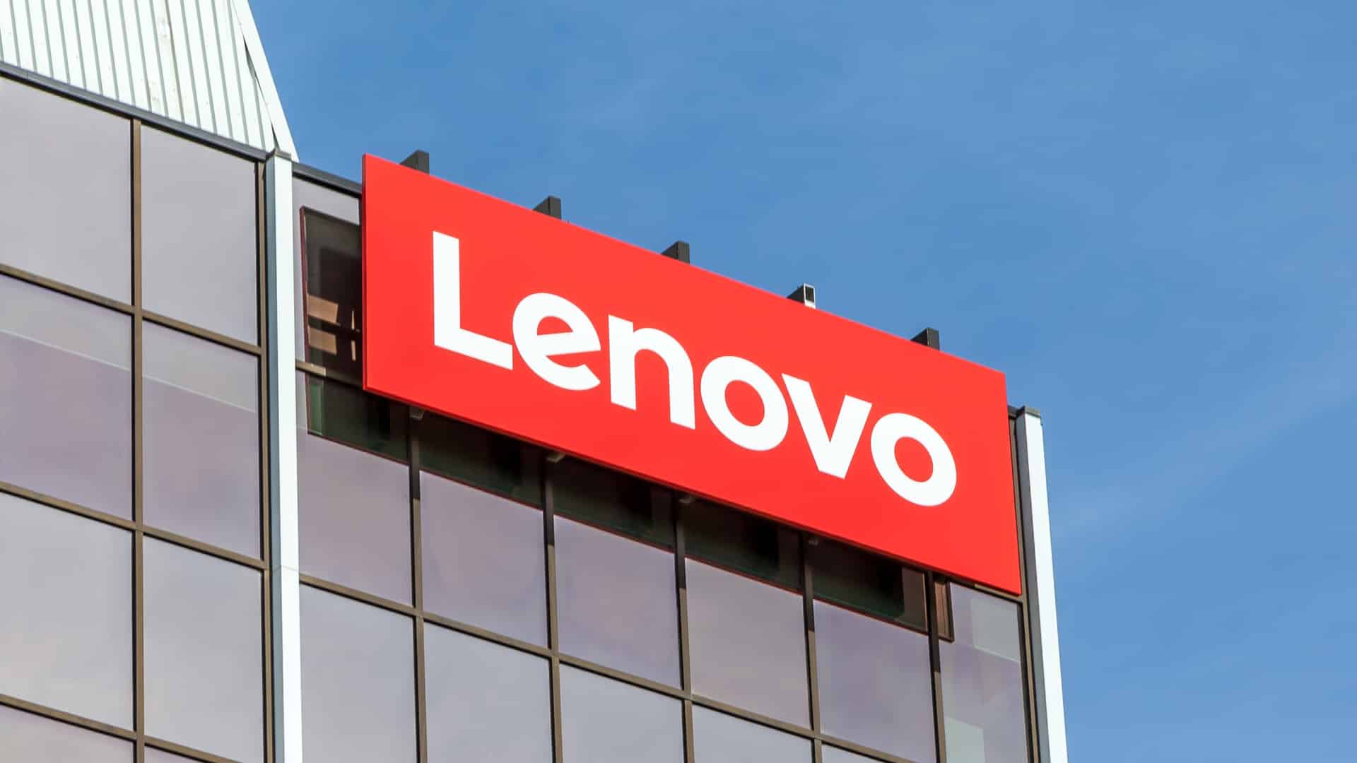 Lenovo corporate logo displayed on the exterior of a modern office building, highlighting the global technology company’s headquarters branding against a clear blue sky.