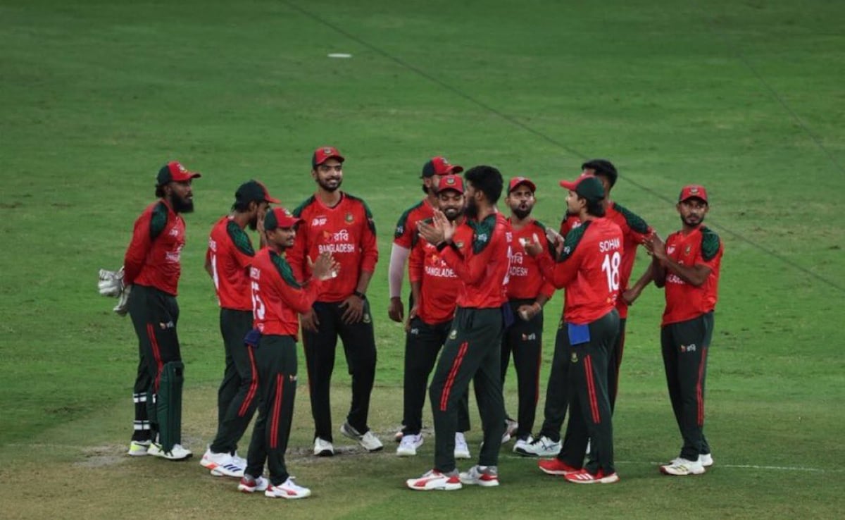 Bangladesh national cricket team players in red jerseys celebrate together on the field during an international match, highlighting team spirit and competitive cricket action in Asia.