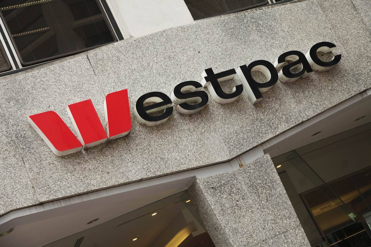 Westpac Banking Corporation logo mounted on the exterior of a commercial office building, highlighting the Australian bank’s branding on a stone façade in an urban business district.