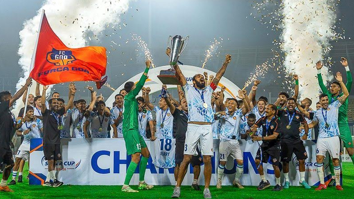 FC Goa players celebrate Super Cup championship victory, lifting trophy amid fireworks and confetti during Indian football tournament final.
