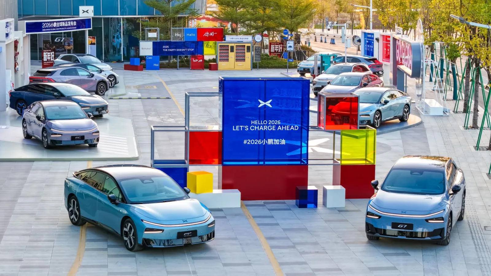 XPeng electric vehicles displayed at a branded outdoor showcase featuring the message “Hello 2026, Let’s Charge Ahead,” highlighting next-generation EV design, smart mobility innovation, and China’s electric vehicle ecosystem ahead of 2026.