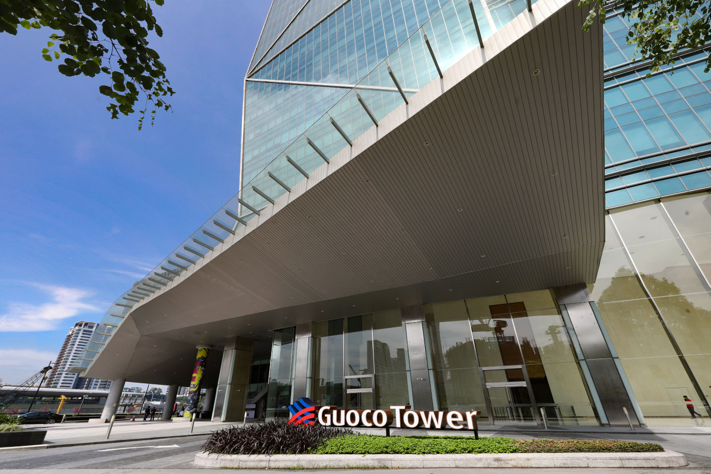Guoco Tower exterior in Singapore’s Tanjong Pagar district, featuring a modern glass façade and mixed-use development that integrates offices, luxury residences, retail spaces, and direct MRT connectivity in the city’s central business district.