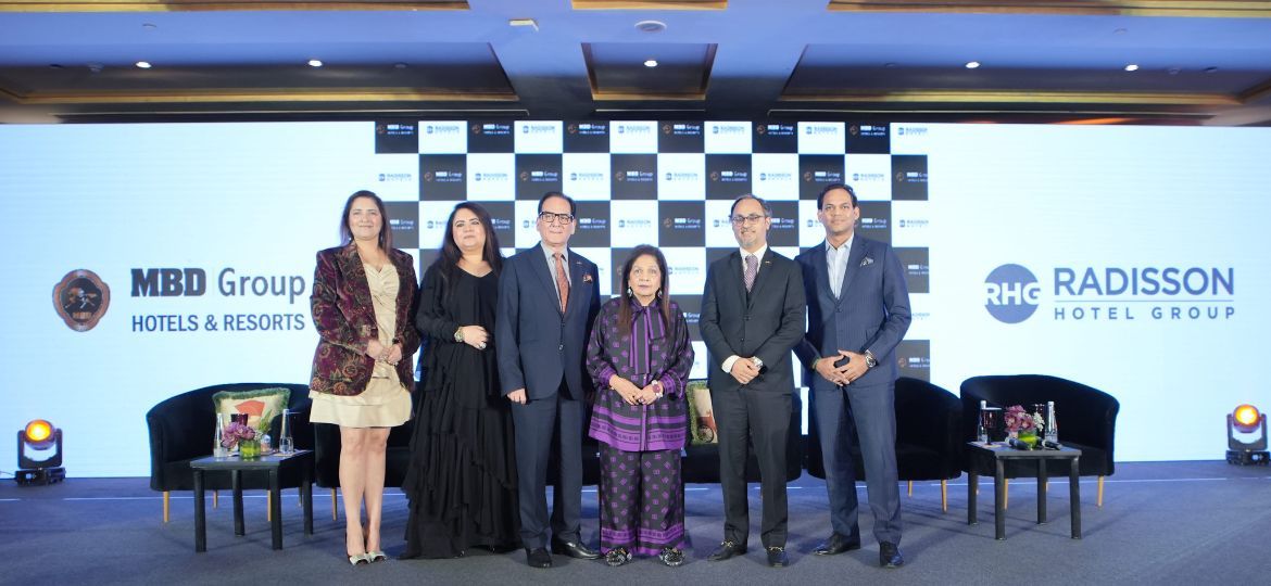 MBD Group and Radisson Hotel Group executives pose at partnership event announcing hotels and resorts collaboration.