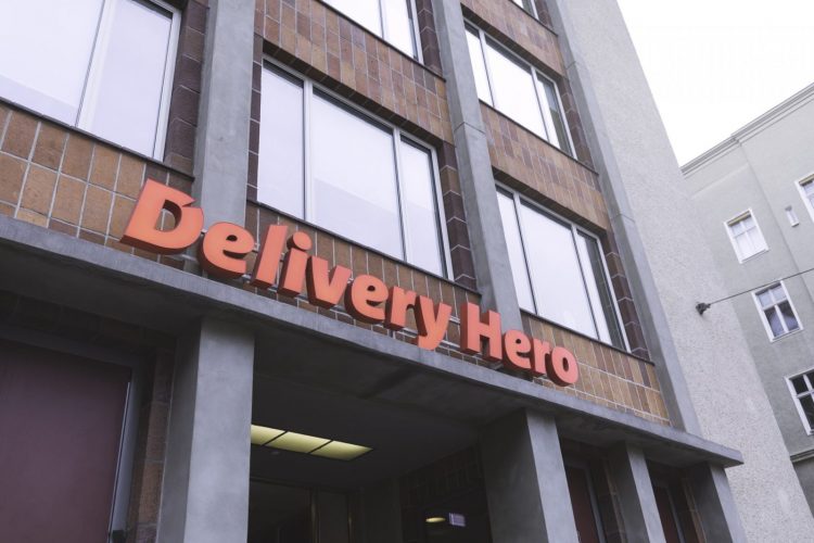 Delivery Hero office building exterior with company logo signage on the facade in an urban setting.