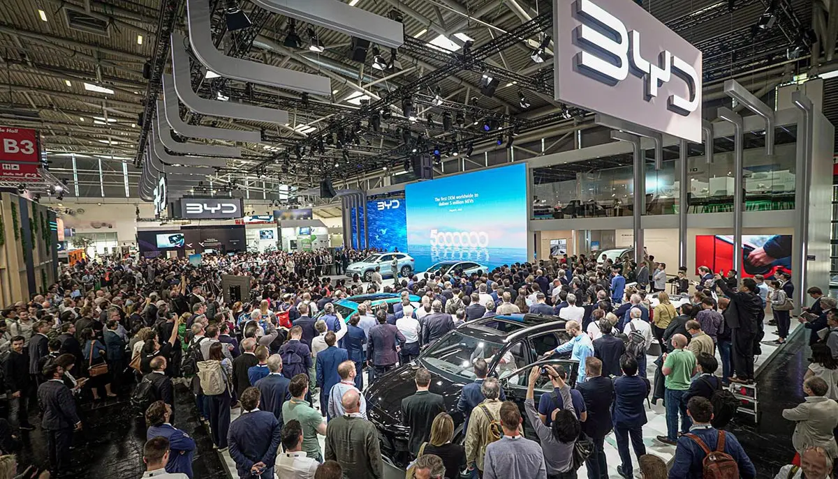 BYD electric vehicle showcase at an international auto expo, featuring a large crowd, new EV models, and the Chinese automaker’s latest innovation in sustainable mobility.