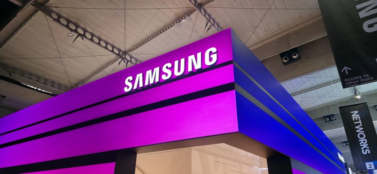 Samsung booth signage at a technology exhibition, featuring illuminated branding and product showcase area in a modern trade show environment.