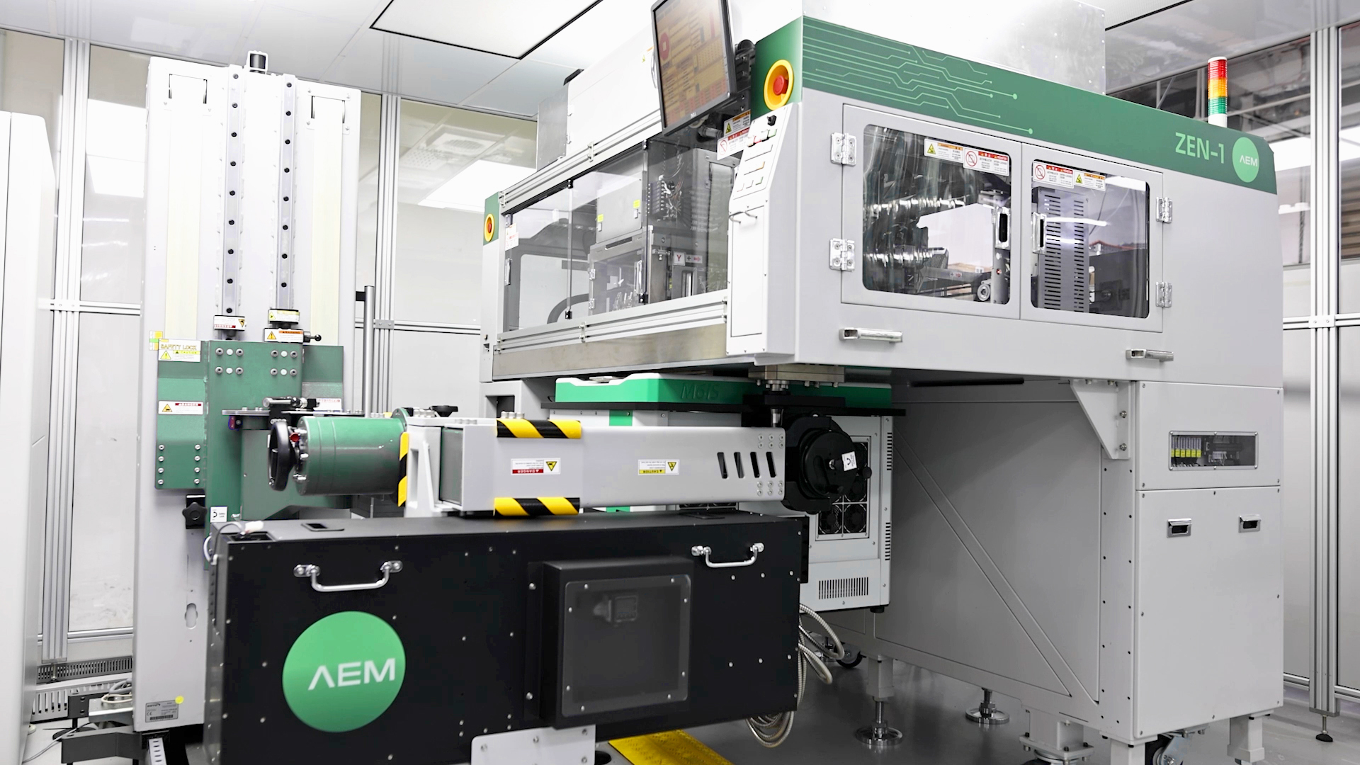 AEM semiconductor testing equipment (ZEN-1 system) in a cleanroom environment, showcasing advanced automation and precision machinery used in chip manufacturing.