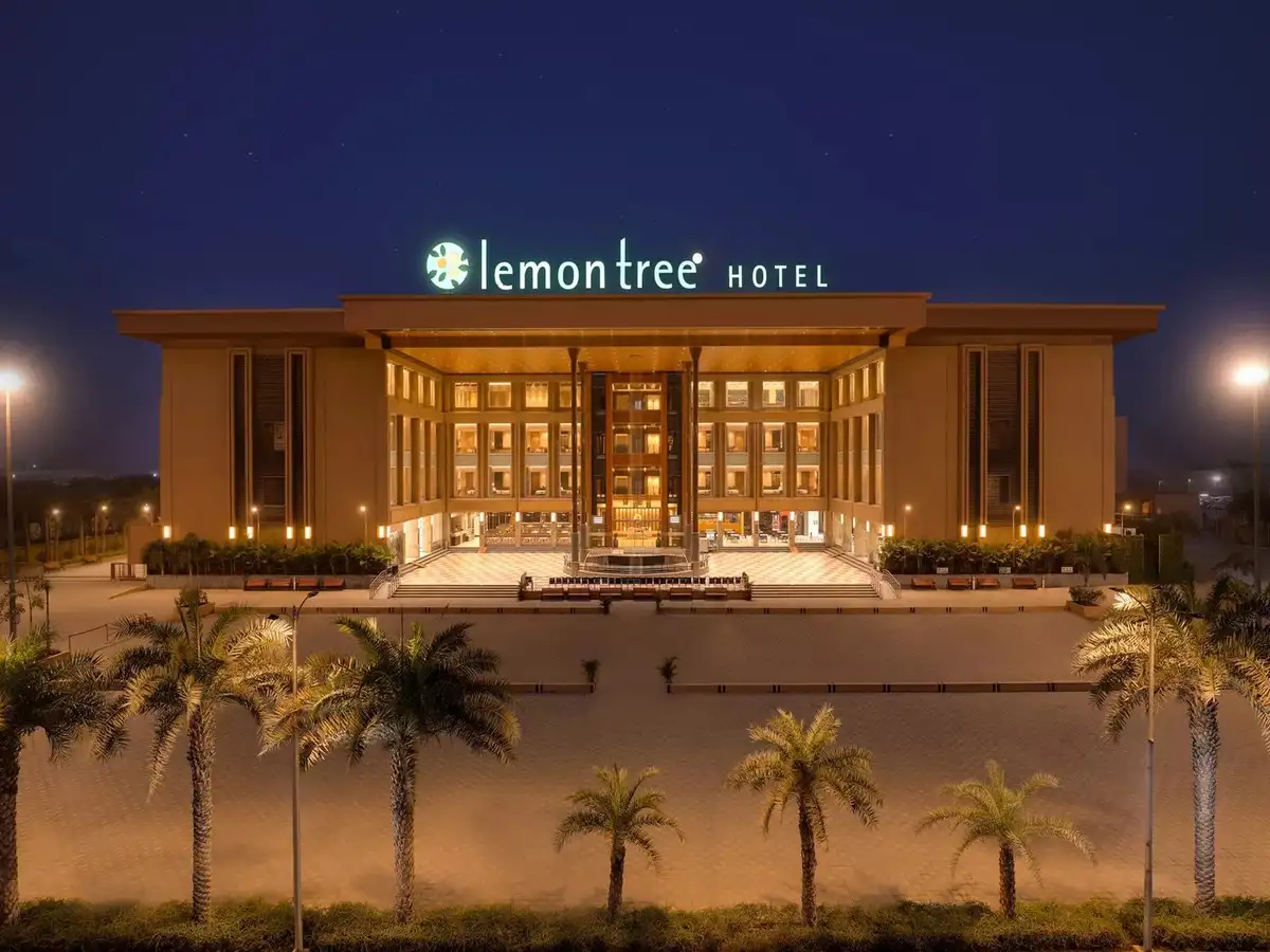 Lemon Tree Hotel exterior illuminated at night, showcasing modern hospitality architecture and luxury accommodation in India.