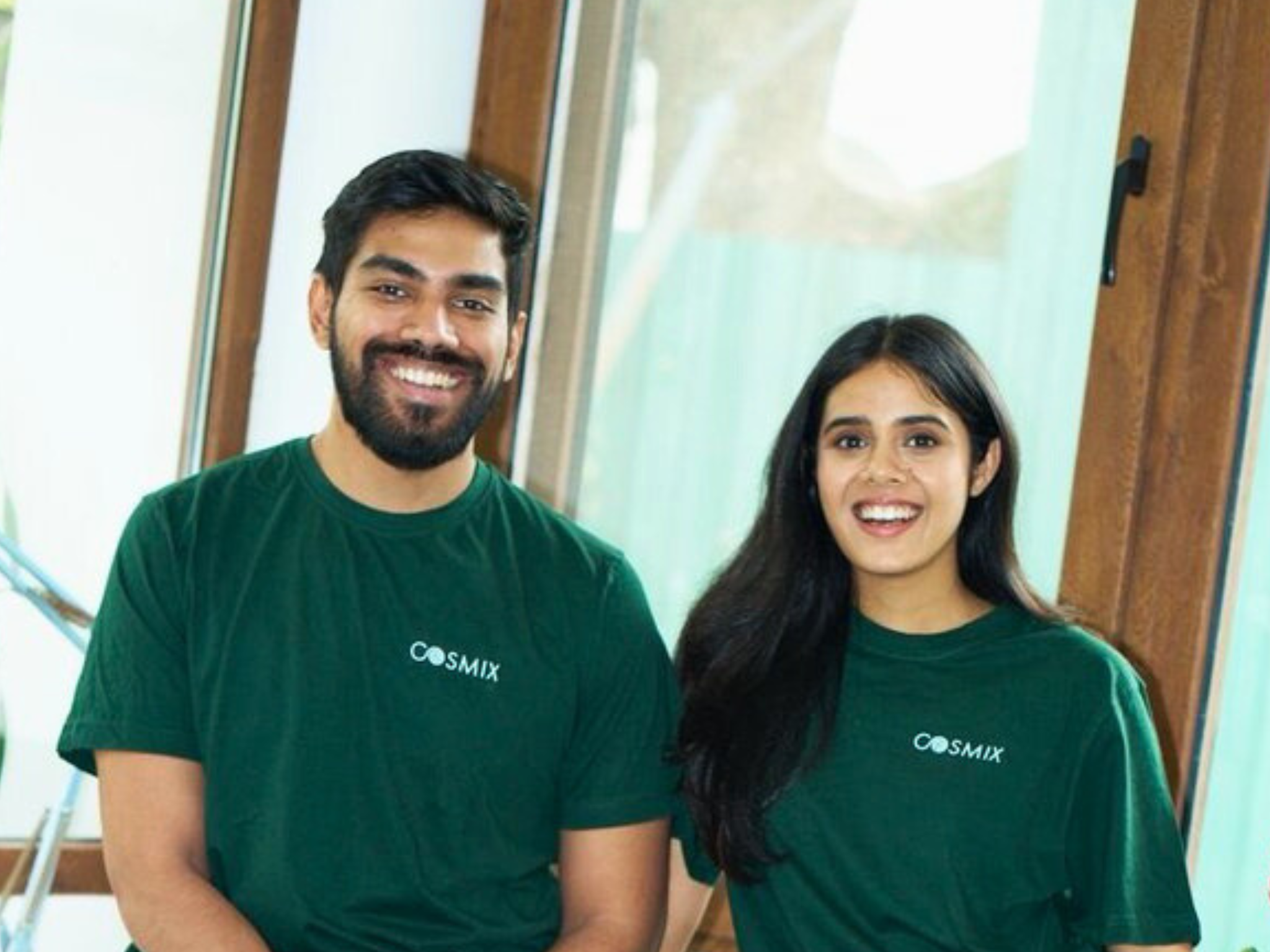 Cosmix founders standing together in branded green shirts, representing a health and nutrition startup focused on clean, plant-based wellness products.