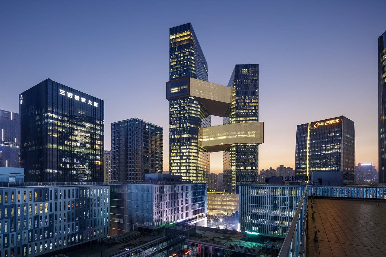 Modern Beijing skyline at dusk featuring Linked Hybrid complex architecture, illuminated skyscrapers, and urban business district development in China.
