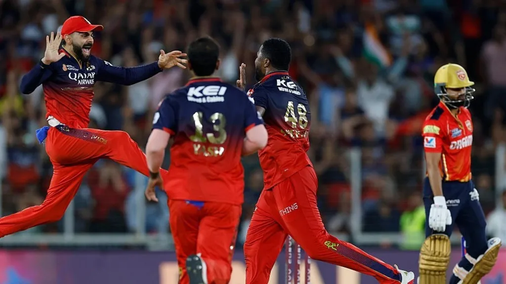 Royal Challengers Bangalore players celebrate wicket during IPL match, highlighting India’s premier cricket league, competitive gameplay, and passionate fan atmosphere.