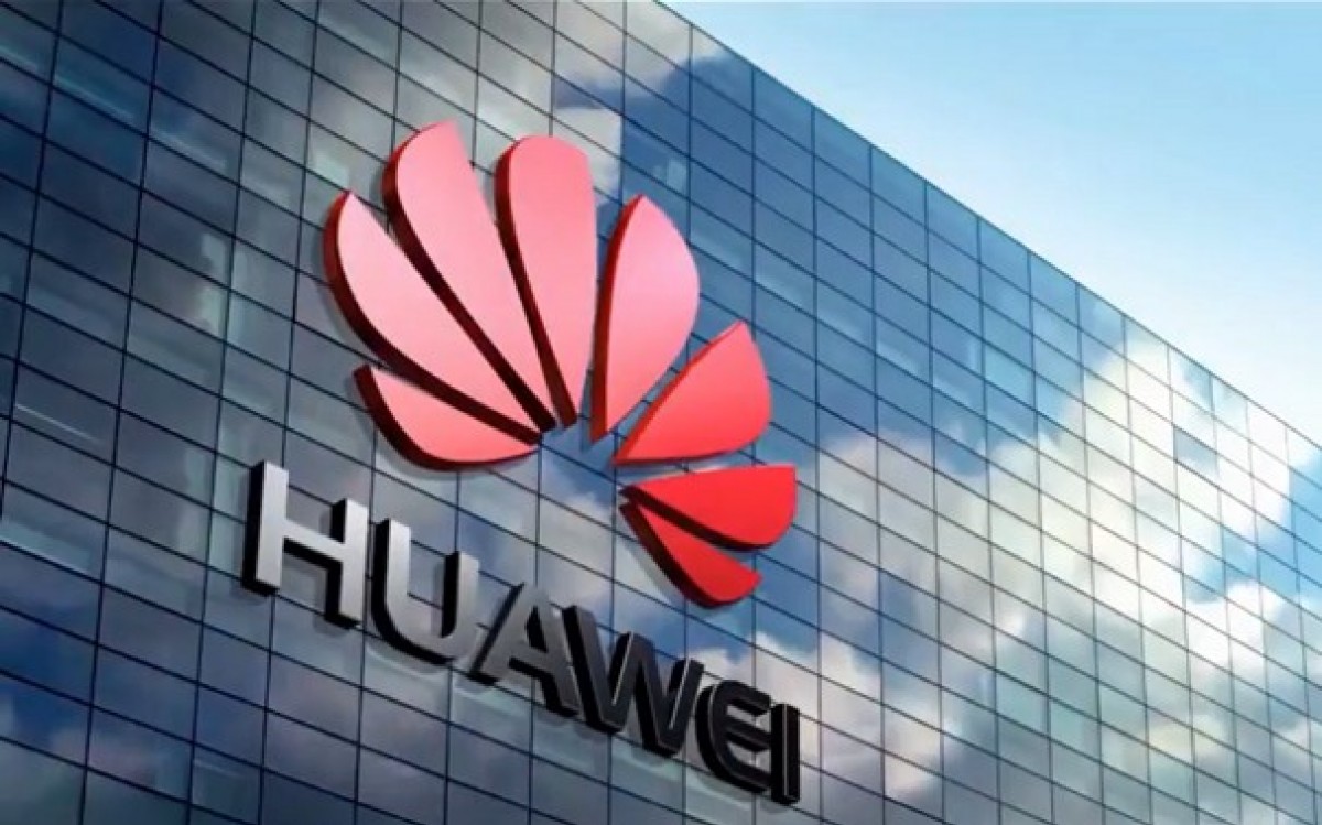 Huawei logo on glass office building exterior, representing global telecommunications, 5G technology, and enterprise digital infrastructure solutions.