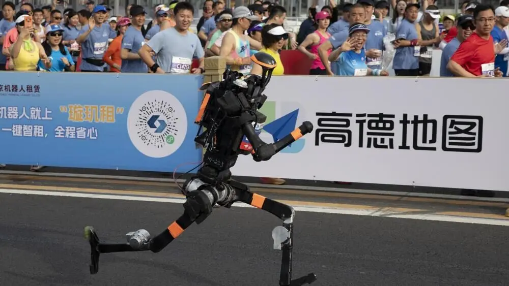 Humanoid robot running in a public marathon in China, showcasing advanced robotics, AI mobility, and human-robot interaction in real-world environments.