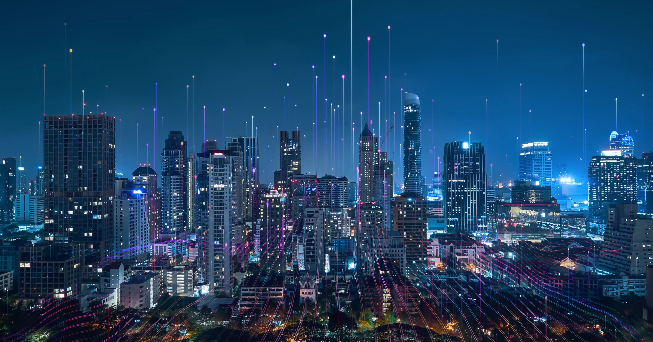 Smart city skyline at night with digital data cloud AI streams and connected network visuals, representing urban innovation, AI infrastructure, and advanced telecommunications technology.