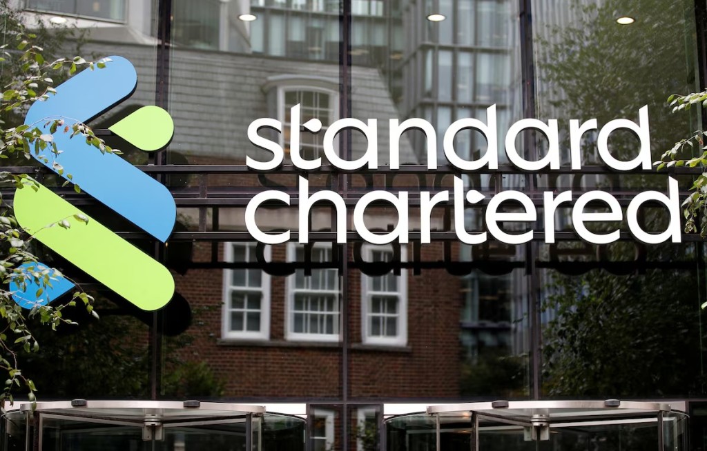 Standard Chartered logo displayed on the exterior of a corporate office building, representing the multinational banking and financial services company.