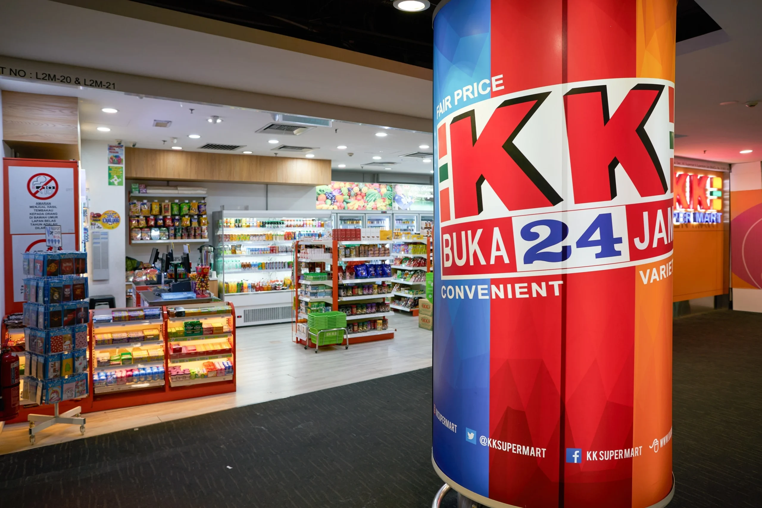 KK Super Mart convenience store interior in Malaysia featuring 24-hour retail services, snack aisles, beverages, and everyday consumer products in a modern shopping environment.