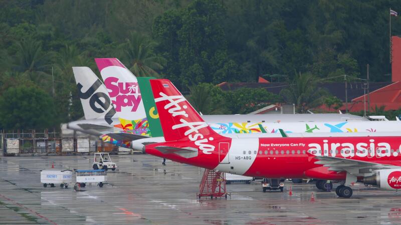 AirAsia and Super Air Jet aircraft parked on a rainy airport tarmac in Southeast Asia, highlighting regional aviation activity, low-cost carriers, and Asia’s growing travel sector.