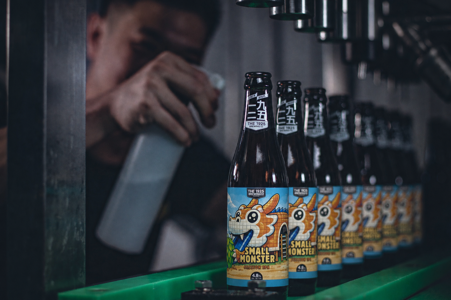 Bottles of The 1925 Brewing Co. Small Monster beer on a production line inside a brewery.